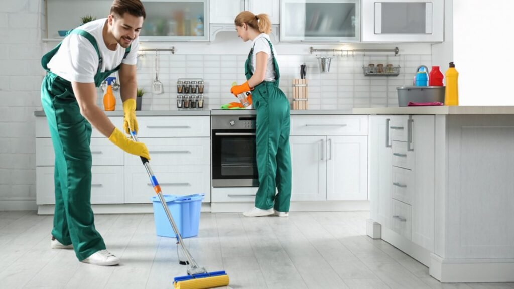 Sparkling clean kitchen countertop with organized utensils, fresh vegetables, and a gleaming sink, showcasing effective kitchen cleaning practices.